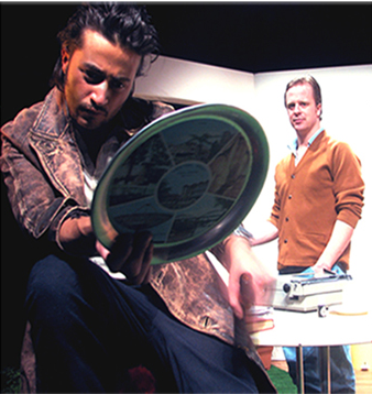 Mark Diaco as Lee holding a decorative plate, Justin Hosking as Austin behind